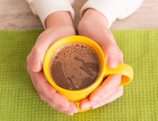 Woman holding coffee cup