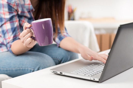 Woman with coffee and laptop